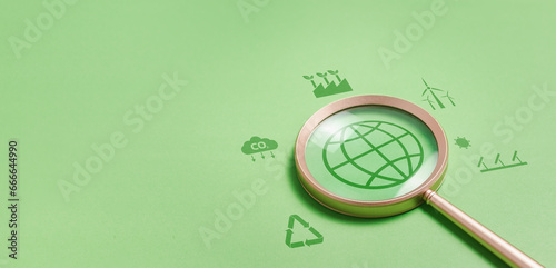 Magnifying glass with reduce CO2 emissions carbon global symbol on green background for climate change to limit global warming and sustainable development and green business concept photo