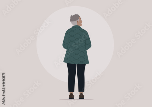 A full-length portrait of a lady with short gray hair, viewed from behind, wearing a casual outfit