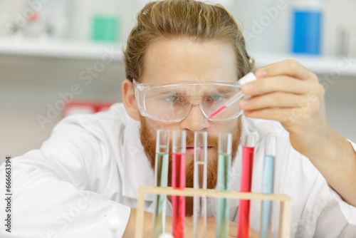 man using pipettes in a lab