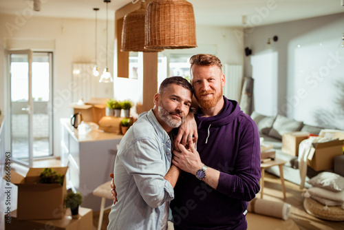 Portrait of a loving hipster gay couple at home photo