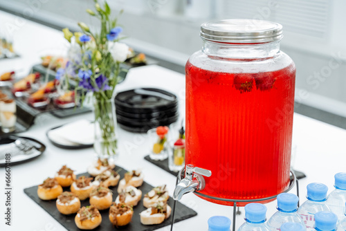 Bilde på lerret Catering in office, juice can, red lingonberry drink, sweet table, festive table setting, drink jug