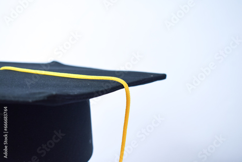 Close-up Black Graduation Hat and Yellow Tassel isolated on white background © ahmadfaiz