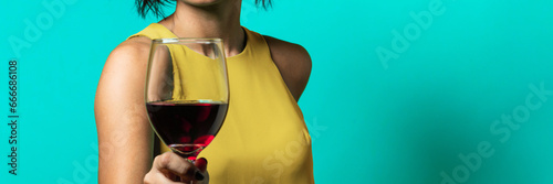 red wine in wineglass - wineglass in hand woman with redwine - horizontal web banner size for header- glass of red wine