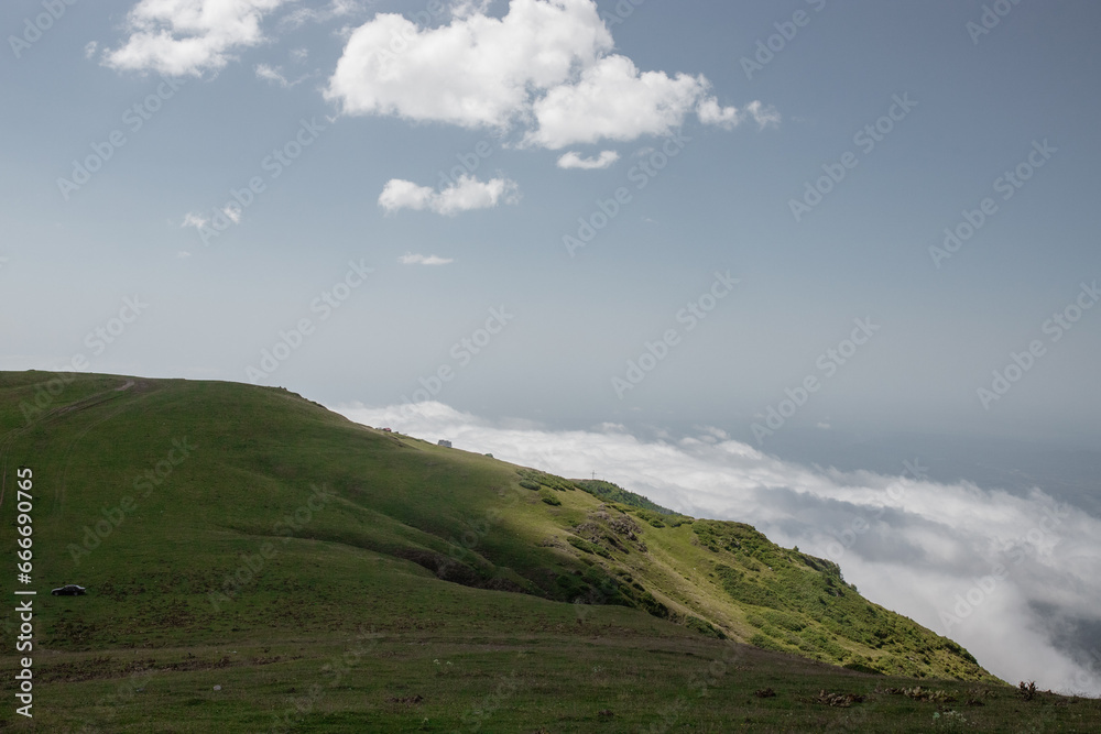 Summer mountain landscape with green hills and clouds: perfect for website design and travel promotion