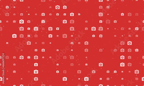 Seamless background pattern of evenly spaced white photo camera symbols of different sizes and opacity. Vector illustration on red background with stars