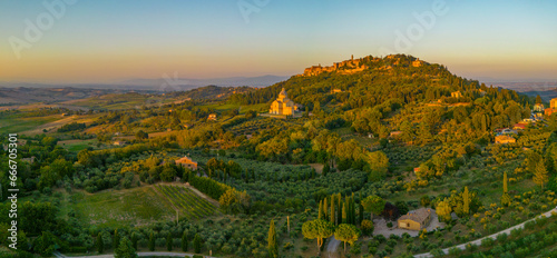 Elevated view of vineyards, olive groves and Montepulciano at sunset, Montepulciano, Tuscany photo