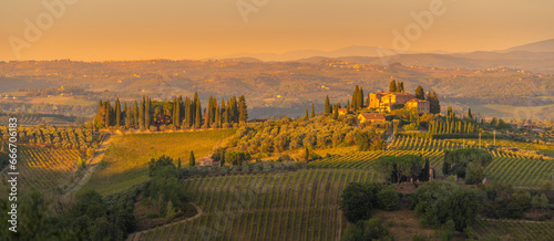 View of vineyards and landscape near San Gimignano at sunset, San Gimignano, Province of Siena, Tuscany photo