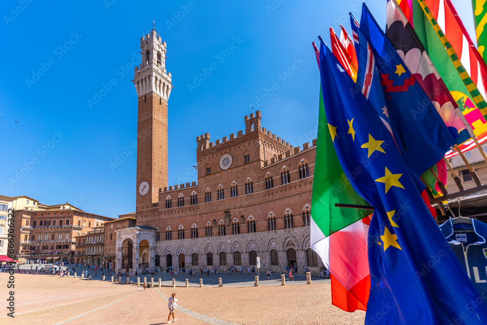View of flags and Palazzo Pubblico in Piazza del Campo, UNESCO World Heritage Site, Siena, Tuscany