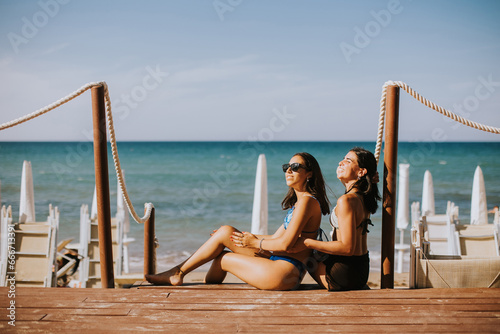 Smiling young women in bikini enjoying vacation on the beach © BGStock72