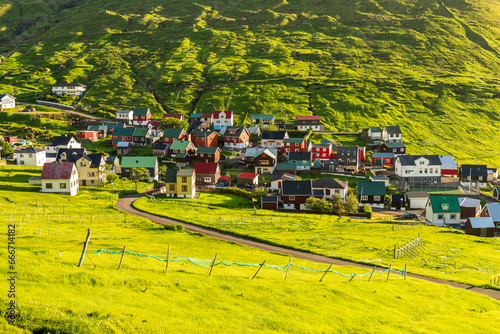 The colorful houses of the fishing village of Funningur at sunrise, Eysturoy island, Faroe islands, Denmark photo