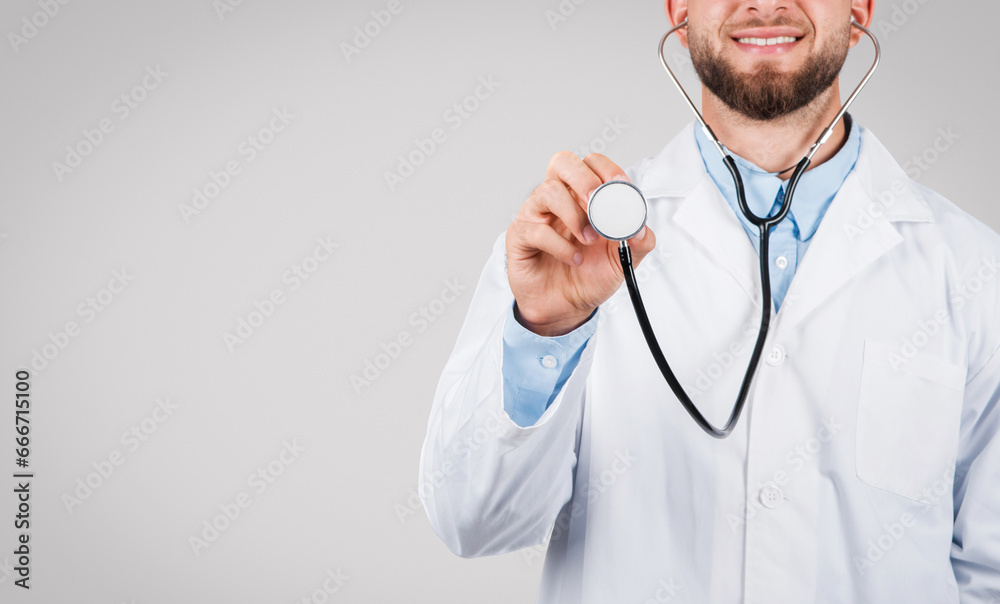 Smiling doctor holding stethoscope, ready for check-up Smiling doctor holding stethoscope, ready for check-up