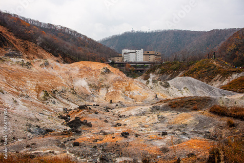 Volcanic sulphur pits in front of a hotel complex, Noboribetsu, Hokkaido, Japan photo