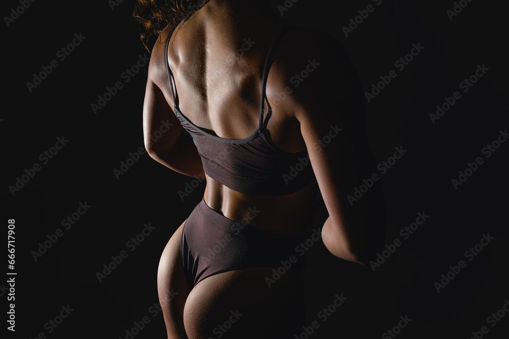 Naklejka premium Cropped image of female body, muscular back, buttocks. Model standing in underwear. Studio background. Concept of natural beauty, body and skin care, health, sport