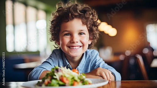 Little boy enjoys his breakfast with coleslaw and salad. photo