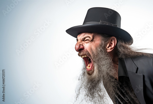 Mature old senior angry Jewish man yelling. Profile side view set against a white background. Vignette. Black hat, cap. Black businessman suit. Gray hair and beard. Long hair, long beard. screaming photo