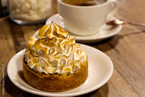 Apple dessert on the background of a tea mug in a cafe on the table, close-up