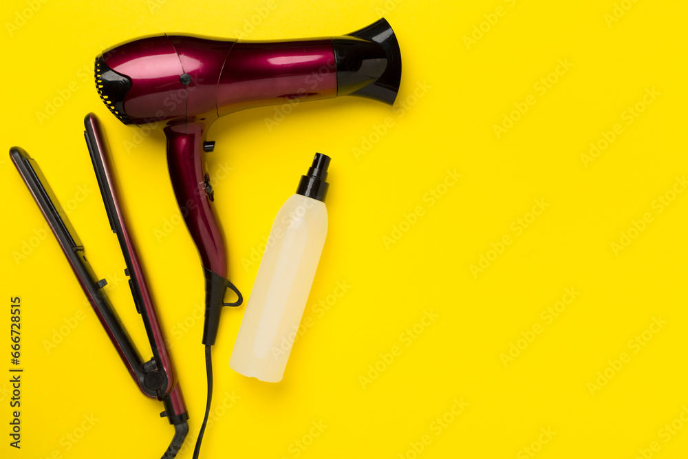 Hair tools with thermo protection on color background, top, view Hair tools with thermo protection on color background, top, view