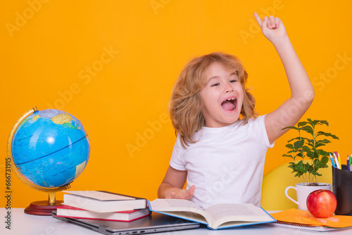 Excited pupil. School kid holding index finger up with great new idea. Child from elementary school with book. Little student, clever nerd pupil ready to study. First time to school.