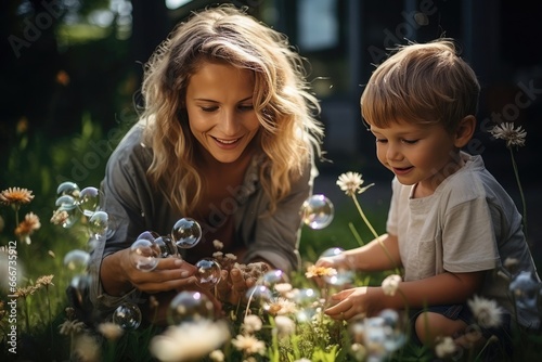 mother and daughter playing in the garden with soap bubbles