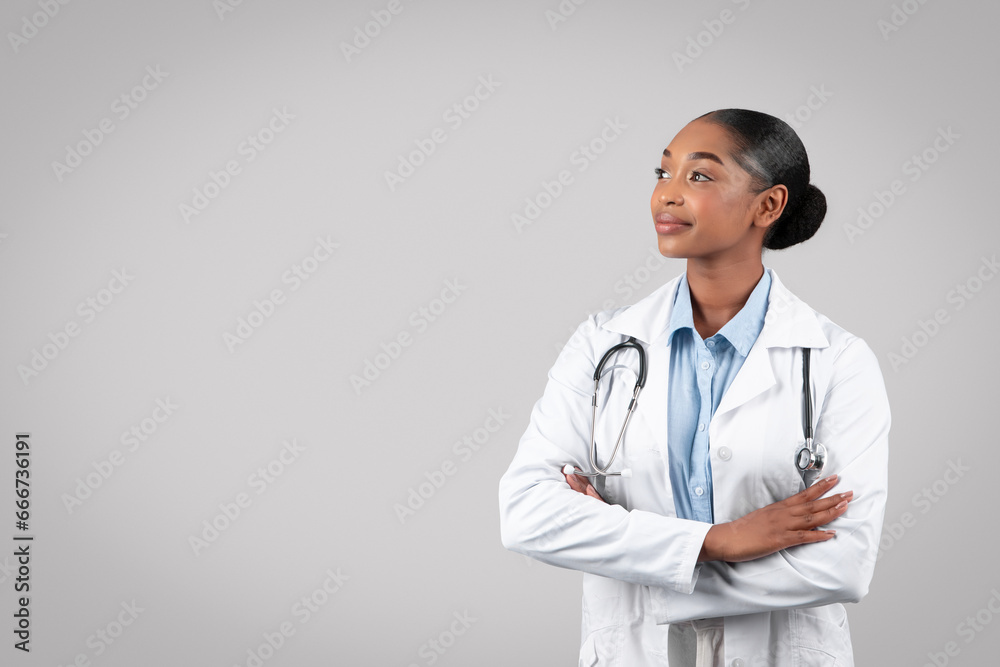 Confident female doctor with stethoscope, looking thoughtful