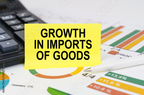 On business reports there is a calculator and a sign with the inscription - growth in imports of goods