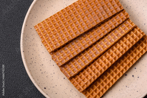 Delicious sweet crispy rectangular waffles on a ceramic plate