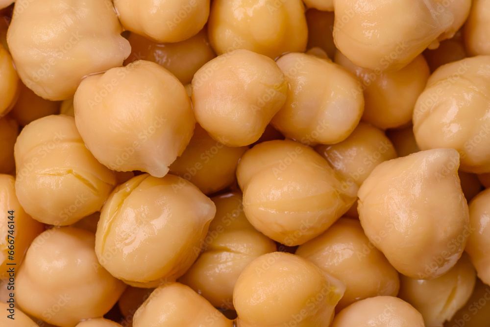 Delicious canned chickpeas in a ceramic plate on a dark concrete background Delicious canned chickpeas in a ceramic plate on a dark concrete background