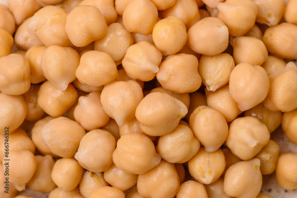 Delicious canned chickpeas in a ceramic plate on a dark concrete background Delicious canned chickpeas in a ceramic plate on a dark concrete background