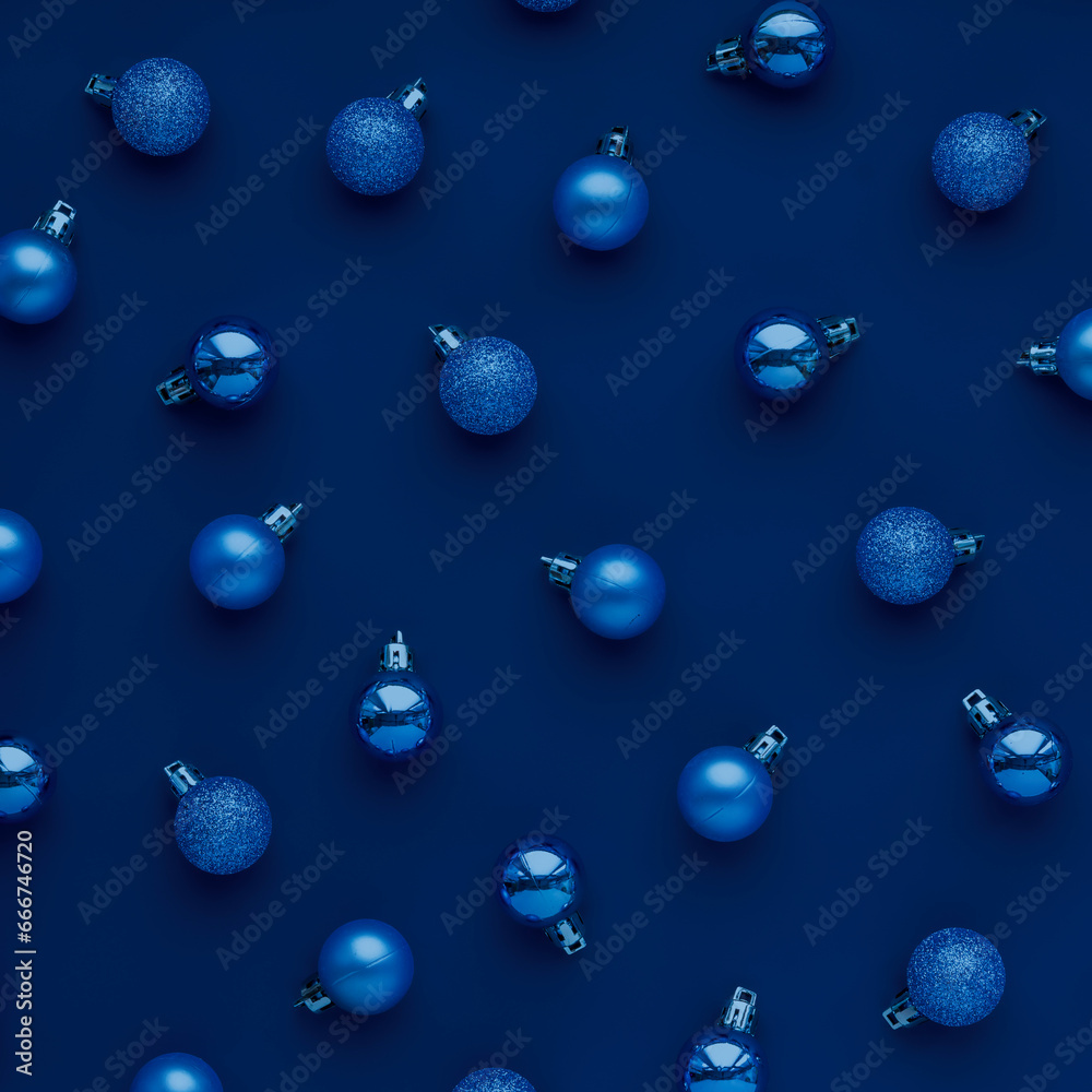 Creative Christmas concept. Pattern of blue Christmas tree balls on dark blue background.
