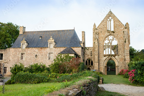The main facade of Beauport Abbey, a roofless gothic building located in Paimpol, Cotes d'Armor, Brittany, France. August 2023, sunset view.