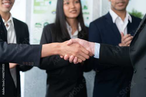 Asian business people shake hand after made successful agreement deal in meeting room, professional hand shaking with applause in corporate company. Quaint © Summit Art Creations
