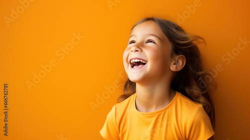 Back to School. Happy Young Girl on a orange