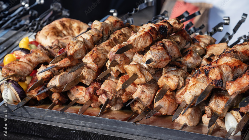 Meat on skewers cooked on a grill. Meat on skewers cooked on a grill.