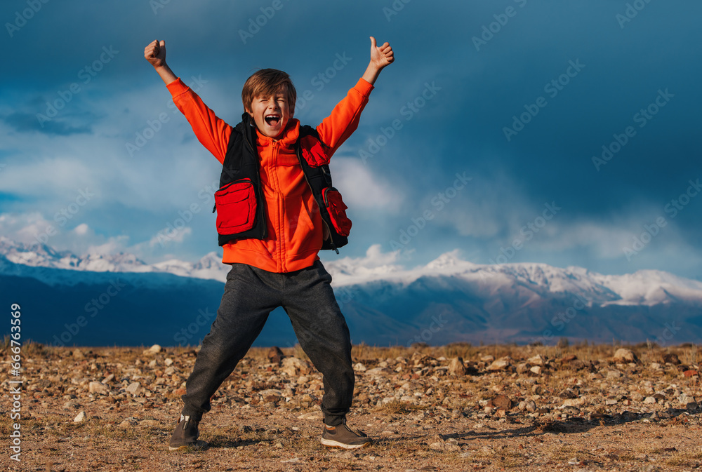 Happy emotional boy tourist on mountains background at autumn Happy emotional boy tourist on mountains background at autumn