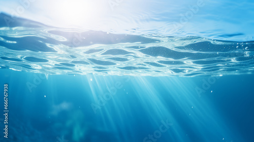 A mesmerizing underwater scene with radiant sunlight piercing through the deep blue ocean