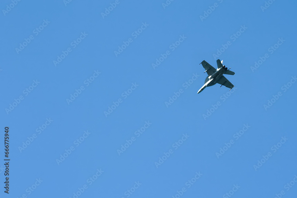 F/A-18 Hornet military jet soaring in a clear blue sky. F/A-18 Hornet military jet soaring in a clear blue sky.
