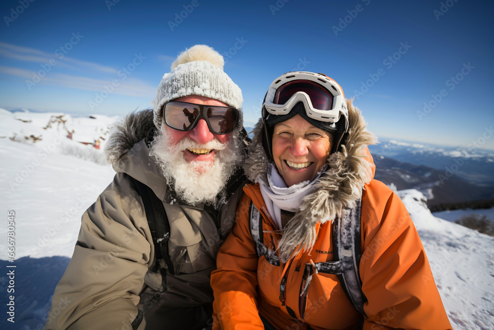 Selfie portrait of senior active smiling mature couple snowboarding skiing in glasses look happy on top of mountains winter day time, happily retired. Active sport elderly healthy lifestyle concept