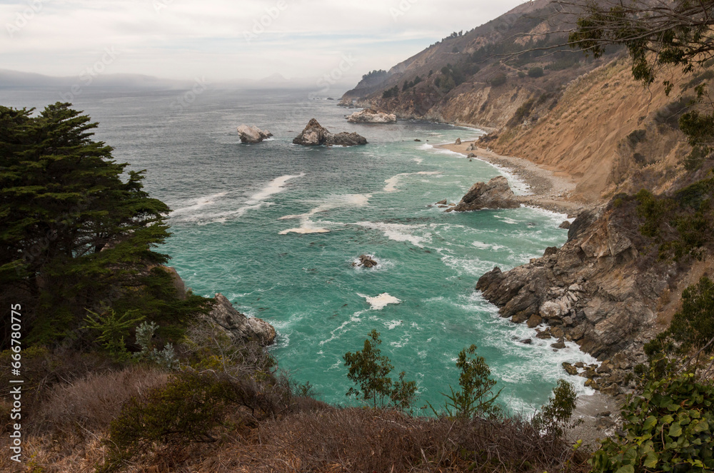 view of Rocky shoreline from McWay Falls Overlook Trail on a cloudy day, California Highway 1, USA view of Rocky shoreline from McWay Falls Overlook Trail on a cloudy day, California Highway 1, USA