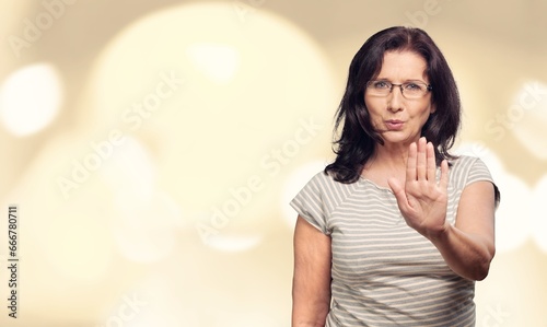 Stop sign. Young woman looking with dislike and showing sign