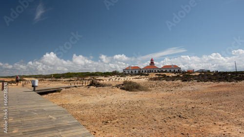 Scenic Fisherman's Trail in Portugal with a Majestic Lighthouse photo