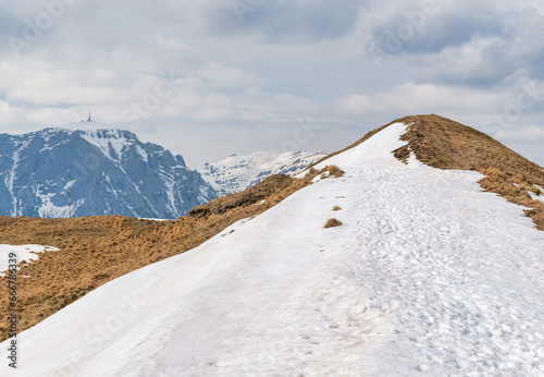 Scenic view from Baiului Mountains with the snowy peaks of Bucegi Mountains. Carpathians in Romania. photo