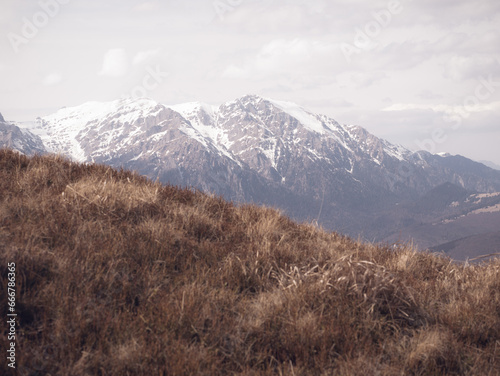 Scenic view from Baiului Mountains with the snowy peaks of Bucegi Mountains. Carpathians in Romania. photo