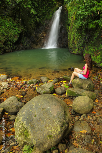 Young woman siting at Seven Sisters Falls, Grenada island, Grenada. photo