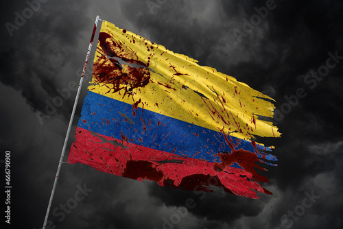 Colombia torn flag on dark sky background with blood stains.