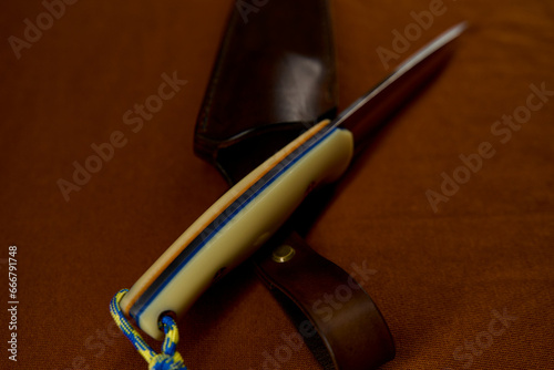 Fotografie Handmade hunting knife in a leather sheath