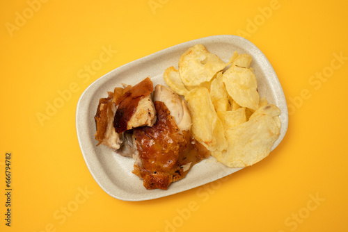 crispy tasty baked piglet and potato in ceramic dish photo