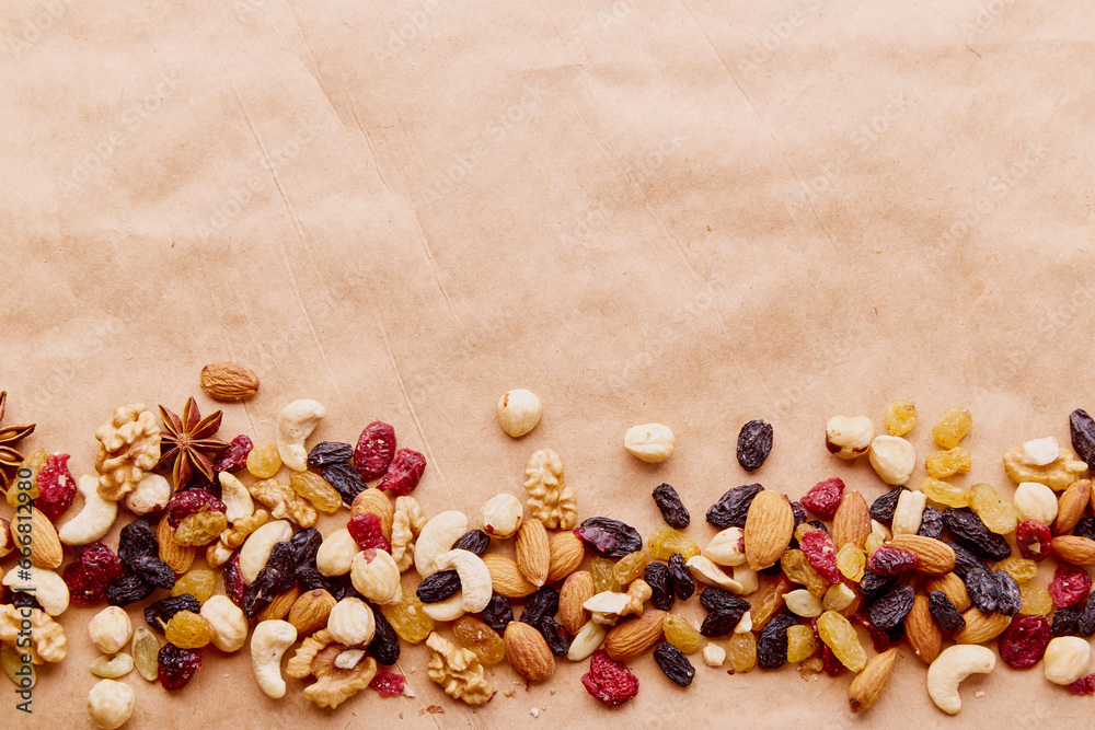 Aesthetics assorted nuts mix in line with copy space. Walnuts, almonds, hazelnuts and cashews, raisins and cranberries. Healthy food and snacks