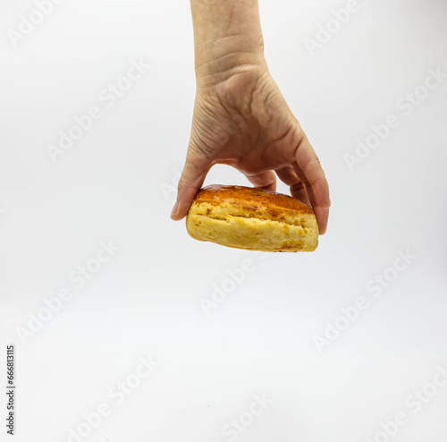 holding whit hand Classic White Biscuits on a White Background photo