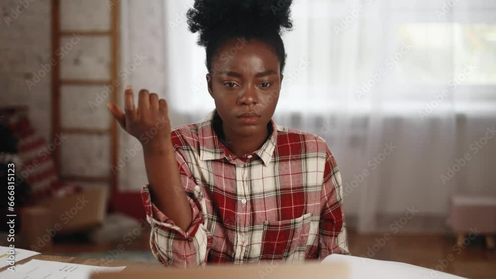 Portrait of pretty creative african american woman student thinks questioningly about difficult choice choose imagine plan in mind has doubts create idea at desk next to laptop at home workplace Portrait of pretty creative african american woman student thinks questioningly about difficult choice choose imagine plan in mind has doubts create idea at desk next to laptop at home workplace