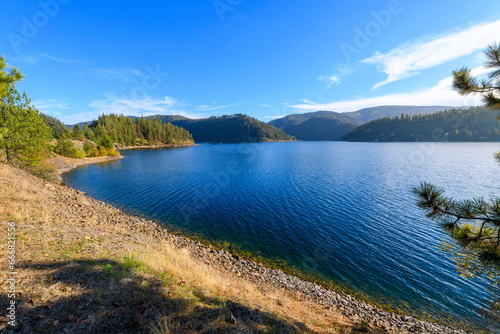 A small beach near the lakefront centennial trail at the Coeur d'Alene Parkway State Park at Higgens Point on the lake at autumn, in Coeur d'Alene, Idaho USA.